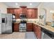 Functional kitchen with stainless steel appliances, granite countertops, and ample cabinet space at 6934 Duffy Ln, Tampa, FL 33616