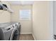 Functional laundry room with washer, dryer, and storage at 6934 Duffy Ln, Tampa, FL 33616