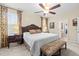 Comfortable main bedroom with a king-sized bed, decorative bench, and large windows with curtains at 6934 Duffy Ln, Tampa, FL 33616