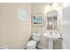 Half bathroom featuring a pedestal sink and neutral decor at 6934 Duffy Ln, Tampa, FL 33616