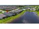Aerial view of a waterfront home, pool, and well-maintained landscaping within a residential community at 7116 Estero Ct, Apollo Beach, FL 33572