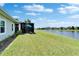 Well-manicured lawn with a pond view and screened patio at 7116 Estero Ct, Apollo Beach, FL 33572
