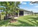 Manicured backyard with a screened patio and water views at 7116 Estero Ct, Apollo Beach, FL 33572