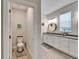 Bathroom showcases a toilet area next to the spacious sink and granite countertop in the ensuite bathroom at 7116 Estero Ct, Apollo Beach, FL 33572