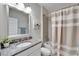 Bright bathroom with granite countertops, decorative mirror, shower and tub combo and neutral paint palette at 7116 Estero Ct, Apollo Beach, FL 33572