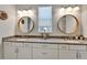 Bathroom features double sinks, granite countertops, decorative mirrors, and updated light fixtures at 7116 Estero Ct, Apollo Beach, FL 33572
