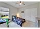 Cozy bedroom featuring a ceiling fan, large window, double door closet and neutral colored walls at 7116 Estero Ct, Apollo Beach, FL 33572