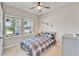 Cozy bedroom with a ceiling fan, a double window view, and carpeted flooring at 7116 Estero Ct, Apollo Beach, FL 33572