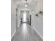 Inviting foyer with wood-look tile flooring, decorative lighting, and neutral wall color at 7116 Estero Ct, Apollo Beach, FL 33572