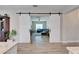 View of the living room with a sliding barn door and tile flooring at 7116 Estero Ct, Apollo Beach, FL 33572