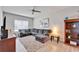 Comfortable living room featuring a large sectional sofa and ceiling fan at 7116 Estero Ct, Apollo Beach, FL 33572