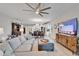 Open-concept living room with natural light, a ceiling fan, and a TV at 7116 Estero Ct, Apollo Beach, FL 33572
