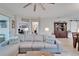 Open-concept living room with plush sofa and view into adjacent office area at 7116 Estero Ct, Apollo Beach, FL 33572