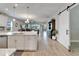 Spacious open-concept living area with a kitchen island, sliding doors, and modern finishes at 7116 Estero Ct, Apollo Beach, FL 33572