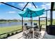 Tranquil screened patio with an outdoor dining area offering picturesque lake views at 7116 Estero Ct, Apollo Beach, FL 33572