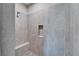 Tiled shower features a built-in bench, tiled niche for toiletries, and modern shower head at 7116 Estero Ct, Apollo Beach, FL 33572