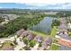 Beautiful aerial view of homes surrounding a pond with lush greenery and water views in the distance at 7509 Tangle Bend Dr, Gibsonton, FL 33534