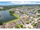 Aerial view of the neighborhood showcasing homes, lush greenery, and a serene lake, capturing the area's natural beauty at 7509 Tangle Bend Dr, Gibsonton, FL 33534