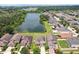 Aerial view of houses near a pond with lush greenery, showcasing the community's natural beauty and lakeside homes at 7509 Tangle Bend Dr, Gibsonton, FL 33534