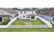 Spacious backyard featuring a white picket fence and covered patio area, great for entertaining at 7509 Tangle Bend Dr, Gibsonton, FL 33534