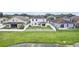 View of the home's backyard, enclosed with a white fence, and lush green space, creating a peaceful outdoor oasis at 7509 Tangle Bend Dr, Gibsonton, FL 33534
