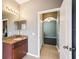 Bathroom vanity with granite counters and view to bedroom at 7509 Tangle Bend Dr, Gibsonton, FL 33534