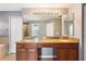 Large bathroom featuring double vanity, tile flooring, and plenty of counter space at 7509 Tangle Bend Dr, Gibsonton, FL 33534
