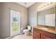 Bathroom features granite counters, and access to backyard at 7509 Tangle Bend Dr, Gibsonton, FL 33534