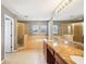 Bright bathroom featuring double vanity, soaking tub, and walk-in shower at 7509 Tangle Bend Dr, Gibsonton, FL 33534
