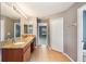 Bright bathroom featuring a double vanity, tile flooring, and access to the bedroom at 7509 Tangle Bend Dr, Gibsonton, FL 33534