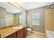 Bathroom with a vanity and a shower with a bathtub next to a window with blinds at 7509 Tangle Bend Dr, Gibsonton, FL 33534