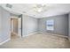 Bright bedroom featuring neutral walls, carpet, and a ceiling fan at 7509 Tangle Bend Dr, Gibsonton, FL 33534
