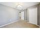 Neutral-toned bedroom with ceiling fan, closet, and carpet flooring at 7509 Tangle Bend Dr, Gibsonton, FL 33534
