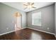 Bedroom with wood floors, ceiling fan, and window with blinds at 7509 Tangle Bend Dr, Gibsonton, FL 33534