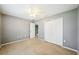 Well-lit bedroom with ceiling fan, closet and doorway to the staircase of the home at 7509 Tangle Bend Dr, Gibsonton, FL 33534