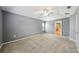 Large bedroom offering neutral walls, carpet, a ceiling fan, and bright natural light at 7509 Tangle Bend Dr, Gibsonton, FL 33534