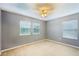 Neutral bedroom with ceiling fan and two windows that provide natural light and pleasant views at 7509 Tangle Bend Dr, Gibsonton, FL 33534