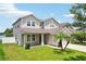 Inviting home exterior showcasing a manicured lawn, palm trees, and a covered porch, creating a warm and welcoming ambiance at 7509 Tangle Bend Dr, Gibsonton, FL 33534