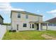 View of the home's exterior and backyard with lawn at 7509 Tangle Bend Dr, Gibsonton, FL 33534
