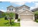Home exterior featuring an attached two car garage at 7509 Tangle Bend Dr, Gibsonton, FL 33534
