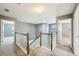 Upstairs hallway with carpet floors and views of bedrooms at 7509 Tangle Bend Dr, Gibsonton, FL 33534