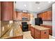 Kitchen features granite counters, stainless appliances, wood cabinetry and an island at 7509 Tangle Bend Dr, Gibsonton, FL 33534