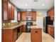 Kitchen features granite countertops, wood cabinetry, and stainless steel appliances at 7509 Tangle Bend Dr, Gibsonton, FL 33534