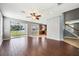 Open living room features wood tile flooring and sliding glass doors to the backyard at 7509 Tangle Bend Dr, Gibsonton, FL 33534