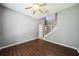 Spacious living room features wood floors, ceiling fan, and staircase at 7509 Tangle Bend Dr, Gibsonton, FL 33534