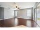 Open living room featuring dark wood flooring and a sliding glass door at 7509 Tangle Bend Dr, Gibsonton, FL 33534