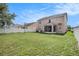 Exterior view of a spacious backyard with well-maintained grass and a white fence at 7641 Armonk Ln, Wesley Chapel, FL 33545