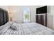 Comfortable bedroom with a well-lit view from the window and a modern dresser at 7641 Armonk Ln, Wesley Chapel, FL 33545