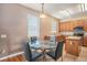 Eat-in kitchen featuring laminate floors, wood cabinetry, stainless appliances, and a kitchen island at 7641 Armonk Ln, Wesley Chapel, FL 33545