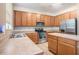Spacious kitchen features stainless steel appliances and wood cabinetry with ample counter space at 7641 Armonk Ln, Wesley Chapel, FL 33545